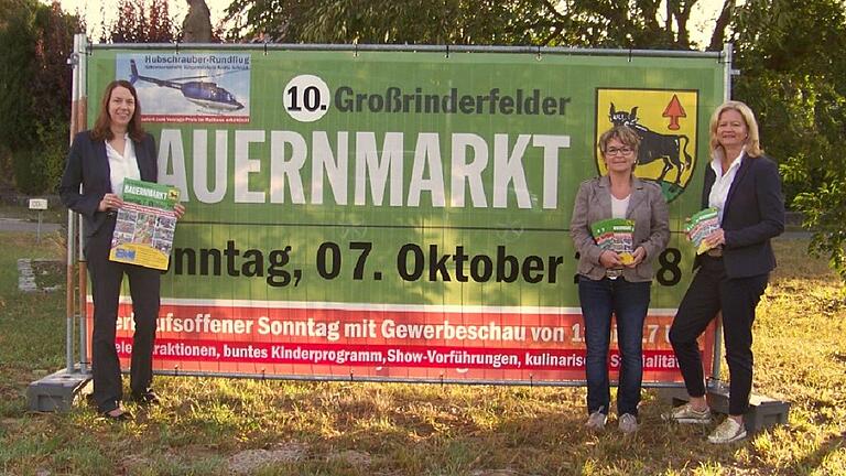 Große Plakatwände weisen schon mal auf den 10. Großrinderfelder Bauernmarkt am 7. Oktober hin. Das Organisationsteam freut sich auf viele Besucher. Im Bild (von links) Ortschaftsrätin Christina Häußler, Monika Zeisner-Menikheim, Bürgermeisterin Anette Schmidt; es fehlt Ortsvorsteher Walter Lutz.