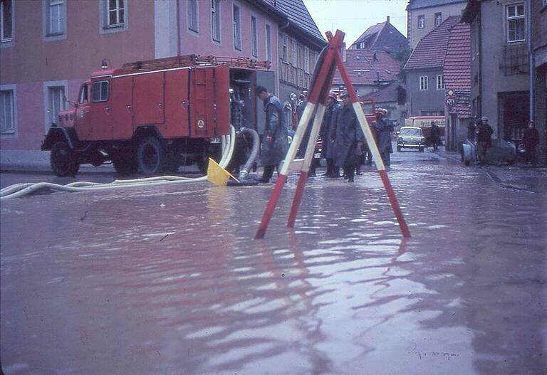 Extremes Hochwasser in Gerolzhofen: Selbst die Kreuzung Schallfelder Straße/Weth/Bleichstraße ist geflutet und das Tanklöschfahrzeug der Freiwilligen Feuerwehr versucht, durch Abpumpen die Kanalisation zu entlasten. Damals sprach man von 'Wetter' und noch nicht von 'Klimawandel'. Das Bild entstand vermutlich in den 60-er Jahren. Extremes Hochwasser in Gerolzhofen: Selbst die Kreuzung Schallfelder Straße/Weth/Bleichstraße ist geflutet und das Tanklöschfahrzeug der Freiwilligen Feuerwehr versucht, durch Abpumpen die Kanalisation zu entlasten. Damals sprach man von 'Wetter' und noch nicht von 'Klimawandel'. Das Bild entstand vermutlich in den 60-er Jahren.