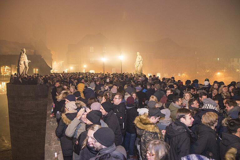 Auf der Alten Mainbrücke darf auf das neue Jahr angestoßen werden, allerdings mit Pappbechern.&nbsp;