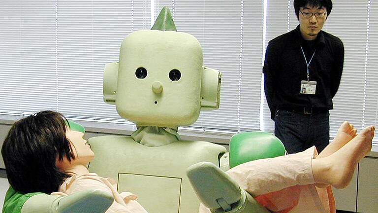 JAPAN-RIKEN-ROBOT - Japan's Institute of Physical and Chemical Research (RIKEN) unveils the new nursing-care robot 'Ri-Man', sweeping up a life-sized doll with his sillicone made soft skin arms during a demonstration of its ability to carry a patient or an elderly person at Riken's laboratory in Nagoya, central Japan 13 March 2006. The Ri-Man, 158cm tall and weighing 100kg, is equipped with five antenna sensors and 19 actuators allowing it to carry a human body while keeping its balance. AFP PHOTO/JIJI PRESS JAPAN-RIKEN-ROBOT - Japan's Institute of Physical and Chemical Research (RIKEN) unveils the new nursing-care robot 'Ri-Man', sweeping up a life-sized doll with his sillicone made soft skin arms during a demonstration of its ability to carry a patient or an elderly person at Riken's laboratory in Nagoya, central Japan 13 March 2006. The Ri-Man, 158cm tall and weighing 100kg, is equipped with five antenna sensors and 19 actuators allowing it to carry a human body while keeping its balance. AFP PHOTO/JIJI PRESS