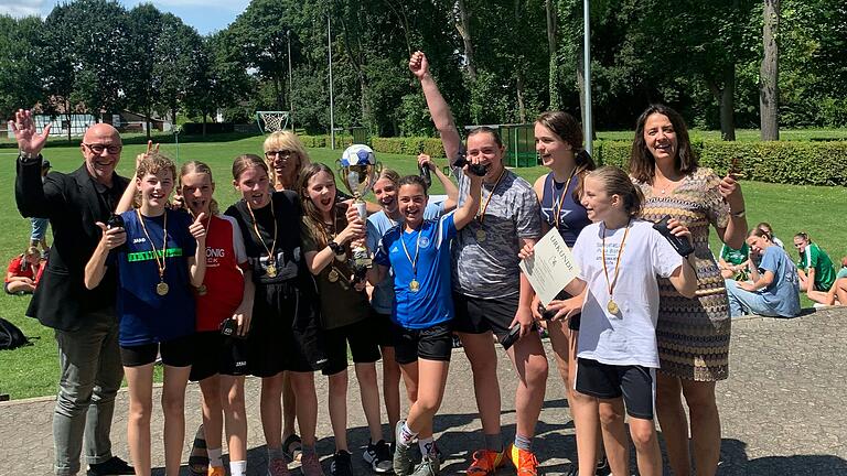 Gewinnermannschaft der Realschule Gerolzhofen: Emma Götz, Lia Hümmer, Jana Krünes, Lara Bory, Nele Häusner, Frieda Kleinhenz, Hanna Brückner, Fee Eisenbarth, Eva Huppmann, flankiert von Schulrat Frank Hagen und Verena Wieland von der Sparkasse Schweinfurt-Haßberge, im Hintergrund Petra Weingart vom Arbeitskreis Schule und Sport.