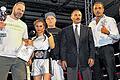 Kickboxerin Pinar Bolat triumphiert im Saarland       -  (pm)   In der &bdquo;Alten Grube&ldquo; von Großrosseln nahe Saarbrücken hat Kickboxerin Pinar Bolat bei der &bdquo;Kampfnacht Fight for Saarland&ldquo; den &bdquo;ProAm-Titel&ldquo; gewonnen. Die 15 Jahre alte Kampfsportlerin des Würzburger Sugambrer Fightclub e. V. setzte sich im K-1-Leichtkontakt-Wettbewerb bis 57 Kilogramm gegen die französische Titelverteidigerin Amandine Falck per technischem K. o. durch. Der Schützling von Trainer Frank Schneider bestimmte das Tempo, landete früh mit Faust und Fuß Treffer, sodass Falck bereits in der zweiten Runde angezählt werden musste. Bolat erhöhte den Druck und beherrschte den Kampf, den der Referee schließlich vorzeitig beendete. Unser Bild zeigt: (von links) Vater Selim Bolat, Trainer Frank Schneider, Pinar Bolat, Sekundant Andre Felde, WMF-Präsident Isa Akkus sowie die beiden Referees.