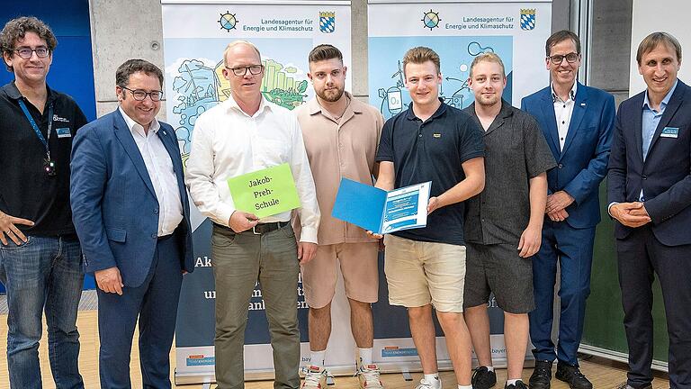 Im Bild Staatssekretär Tobias Gotthardt (Zweiter von links), Prof. Dr. Ralph Schneider, Präsident der Ostbayerischen Technischen Hochschule Regensburg (Zweiter von rechts) mit Fachschulkoordinator Markus Weiglein, den Schülern Nico Reininger, Sebastian Gerhard und Pascal Zalachowski sowie Mitgliedern des Jury-Teams.