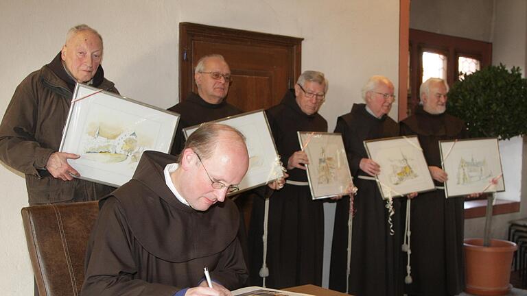 Abschied aus Dettelbach mit einem Eintrag ins Goldene Buch der Stadt für (vorne) Bruder Konrad Haas und hinten von links: Pater Berthold Türrfs, Pater Johannes Strobl, Bruder Martin Domogalla, Pater Alexander Weissenberger und  den Guardian Pater Richard Heßdöfer.