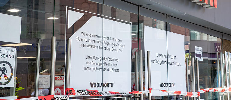 Plakate am Kaufhaus Woolworth informieren die Kunden.