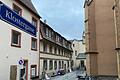 Mitten in der Volkacher Altstadt liegt hinten links in der Klostergasse ein Gebäude des Klosters, das verkauft wurde und nun zu fünf Wohnungen umgebaut wird. Direkt gegenüber befindet sich der Seiteneingang der Stadtkirche St. Bartholomäus. Am Ende der Gasse liegt der Eingang zum Kloster und zu dessen Kapelle.