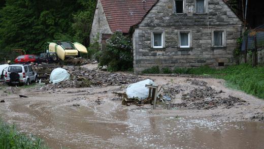 Hochwasser 3       -  Am schlimmsten hat das Unwetter im Bereich der Passmühle gewütet. Ein Sturzbach von bis zu 1,5 Metern Höhe riss fünf Autos und eine landwirtschaftliche Ballenpresse mit sich. Anwesen standen unter Wasser. Den Schaden schätzt die Polizei alleine hier auf über 150.000 Euro.