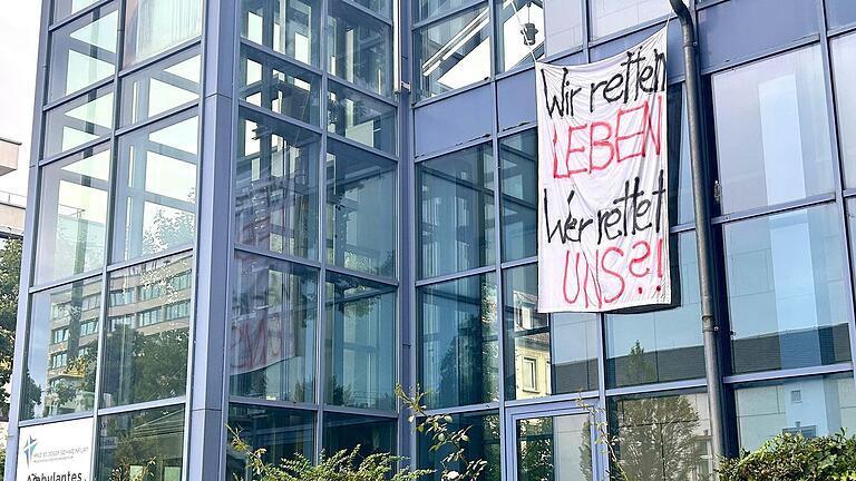Am Krankenhaus St. Josef in Schweinfurt hängen nach der Nachricht, dass es zum 31. Dezember geschlossen wird, mehrere Banner der Mitarbeitende, die ihre Sorge über die Zukunft ausdrücken.
