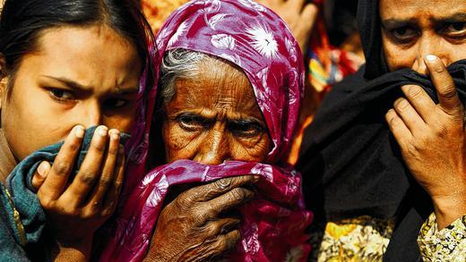 Entsetzen: Frauen bedecken ihre Nasen, um nach dem Brand bei Dhaka den Geruch verbrannter Leichen von sich fernzuhalten. Entsetzen: Frauen bedecken ihre Nasen, um nach dem Brand bei Dhaka den Geruch verbrannter Leichen von sich fernzuhalten.