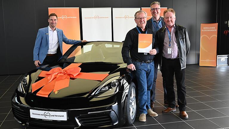 Der glückliche Gewinner Thomas Fischer (Dritter von rechts) vor seinem neuen Porsche Boxster. Mit im Bild (von links) Markus Eichenseer (VR-Gewinnsparverein Bayern), Markus Merz (Vorstandssprecher der VR-Bank Main-Rhön) und Ehrhard Rottenberger. Der glückliche Gewinner Thomas Fischer (Dritter von rechts) vor seinem neuen Porsche Boxster. Mit im Bild (von links) Markus Eichenseer (VR-Gewinnsparverein Bayern), Markus Merz (Vorstandssprecher der VR-Bank Main-Rhön) und Ehrhard Rottenberger.