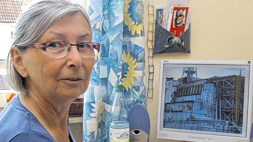 Erinnerungen: Christine Müller mit dem Ordner über die Ferienaufenthalte der Kinder aus Tschernobyl. Auf dem Bildschirm eine Aufnahme des zerstörten Reaktorblocks. Erinnerungen: Christine Müller mit dem Ordner über die Ferienaufenthalte der Kinder aus Tschernobyl. Auf dem Bildschirm eine Aufnahme des zerstörten Reaktorblocks.