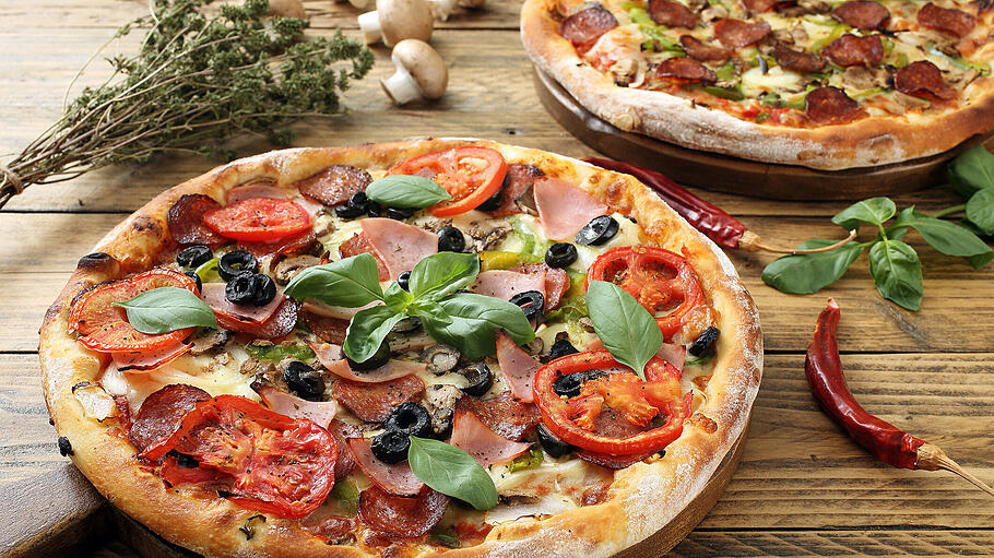 pizza       -  pizza with ham tomato slice and pepperoni on rustic wooden table