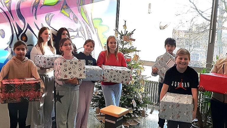 Schülerinnen und Schüler der Klasse 6a der D.-Paul-Eber-Mittelschule Kitzingen mit ihren Weihnachtspäckchen.