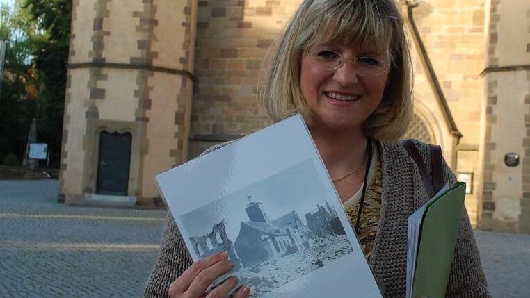 Anja Gareiß-Castritius vor der Johanniskirche mit einem Foto der zerstörten Kirche. Anja Gareiß-Castritius vor der Johanniskirche mit einem Foto der zerstörten Kirche.