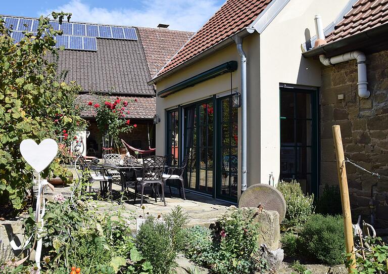 Den abschüssigen Garten am Haus terrassierten die Besitzer. Vor dem angebauten Wohnzimmer entstand eine von Grün umgebene Terrasse.