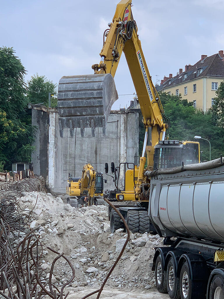 Die Baumaschinen arbeiten sich vor. Im Hintergrund ragen die höchsten Reste des Hohlkastens auf, der die Johann-Sperl-Straße 50 Jahre lang trug.