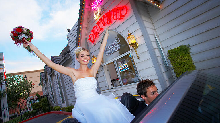 Wedding bride celebrating in convertible       -  Heiraten in Las Vegas ist im Vergleich zu Deutschland recht unkompliziert. Damit die Ehe aber ohne große Mühe zu Hause anerkannt wird, sollte man einige Dinge wissen.