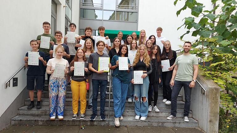 Auf dem Foto sind die erfolgreichen PET-Teilnehmerinnen und Teilnehmer mit der Englischlehrkraft Paul Goldbach zu sehen.&nbsp;