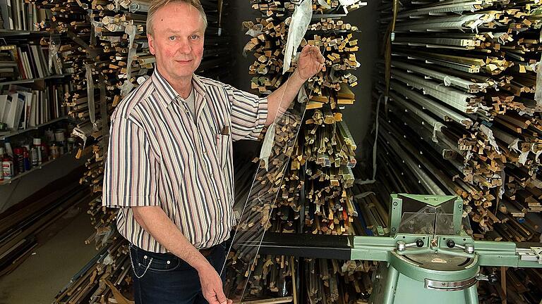 Ullrich Wegner in seiner Werkstatt: Hier werden die Rahmen gefertigt, die Gläser zugeschnitten und die Fotos aufgezogen.