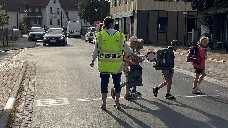 Schulweghelfer sind wichtig, damit Grundschülerinnen und -schüler sicher die Straße überqueren können. Das Foto entstand im Juli 2023 in Langenprozelten.