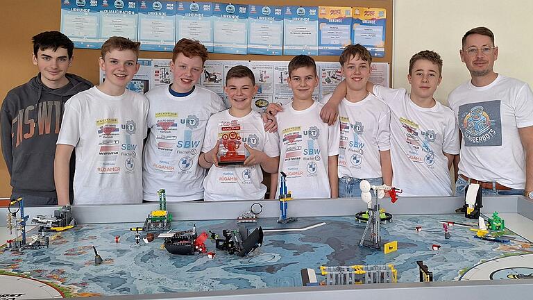 Die 'Glauberbots' mit ihren Robotik-Lego-Modellen sowie ihrem Coach Michael Rappl.