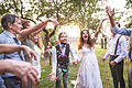 Bride, groom and guests throwing confetti at wedding reception outside.       -  Bride, groom and their guests throwing confetti at the wedding reception outside in the backyard. Family celebration.