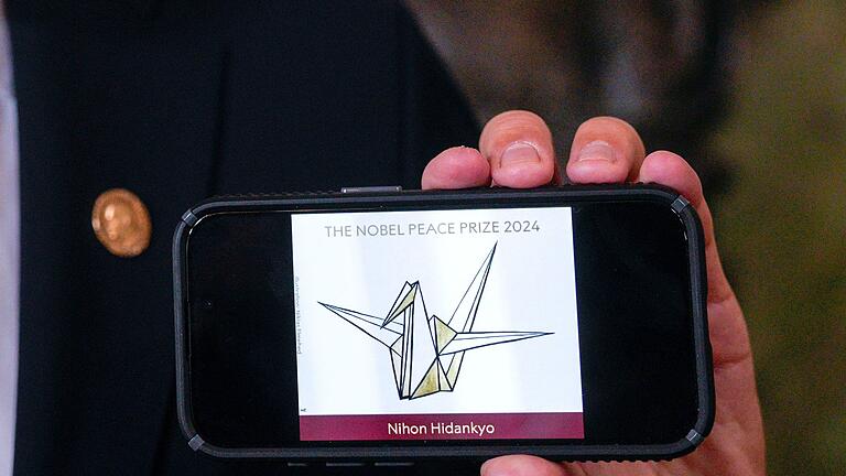 Friedensnobelpreis - Bekanntgabe - Das Logo der japanischen Organisation Nihon Hidankyo zeigt eine stilisierte Friedenstaube. Friedensnobelpreis - Bekanntgabe - Das Logo der japanischen Organisation Nihon Hidankyo zeigt eine stilisierte Friedenstaube.