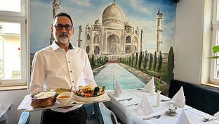 Taj Curryhaus in Bad Kissingen       -  Ujjäger Singh mit Reis, 'Chicken Korma' und 'Tandoori Mix' in seinem indischen Restaurant am Marktplatz.