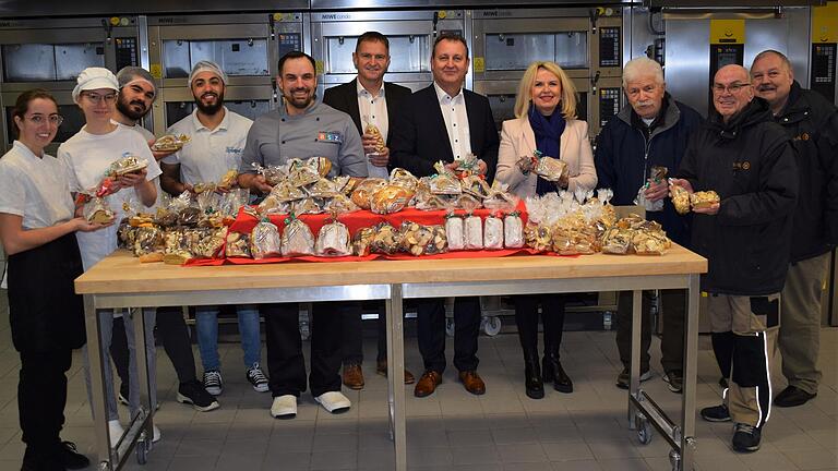 Lucia Toledo Rodriguez, Aimée Kraft, Emre Can-Ugru, Mustafa Nasrullah, Marcus Weiser, Robert Schöfer (Schulleiter i.V.) Andreas Breitenbacher (Leiter des Staatlichen Schulzentrums), Landrätin Tamara Bischof übergeben Manfred Seigner, Horst Zimmermann und Eduard Gossler das Weihnachtsgebäck zugunsten der Kitzinger Tafel