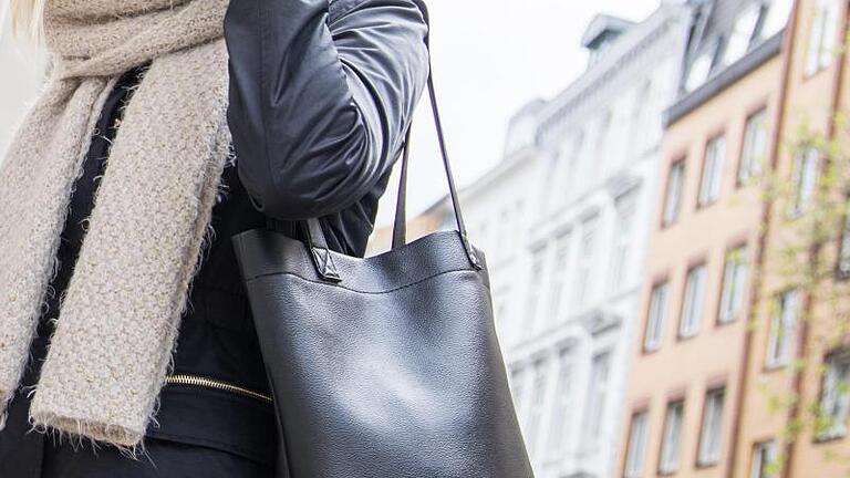 Oft haben Frauen eine «Lieblingsseite», auf der sie ihre Handtasche tragen - doch das sorgt für eine einseitige Belastung, die auf Dauer zu Rückenschmerzen führen kann. Foto: Christin Klose/dpa-tmn       -  Die Handtasche ist immer dabei - aber wohin mit der Tasche im Restaurant?