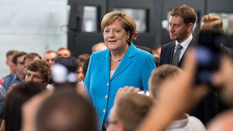 Merkel zu Besuch beim Trumpf in Sachsen       -  In der Union ist erneut eine Diskussion darüber ausgebrochen, mit welchen Parteien Koalitionen denkbar sind. Am Donnerstag besuchte Angela Merkel ein Maschinenbau-Unternehmen im sächsischen Neukirch. Rechts neben ihr: Ministerpräsident Michael Kretschmer.