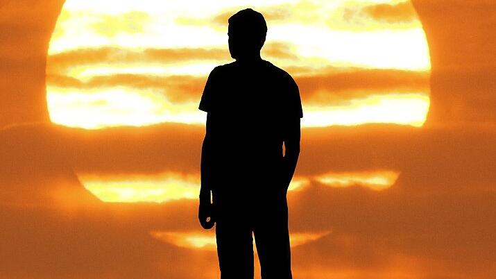 Sunset landscape with silhouette of a man with raised-up arms - Dieser Briefgeht an: aus Sommerhausen Sunset landscape with silhouette of a man with raised-up arms - Dieser Briefgeht an: aus Sommerhausen
