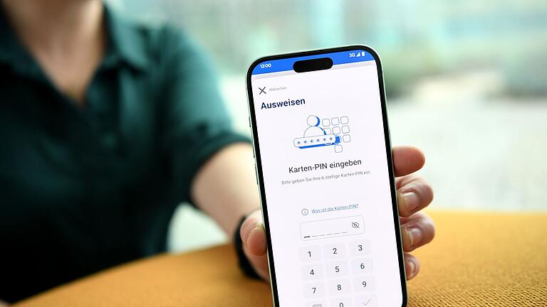 Eine Frau hält ein Smartphone mit der Ausweis App in der Hand       -  Alles sicher und verschlüsselt: Die auf dem E-Perso gespeicherten Daten werden nur übertragen, wenn man sie mit per PIN freigibt.