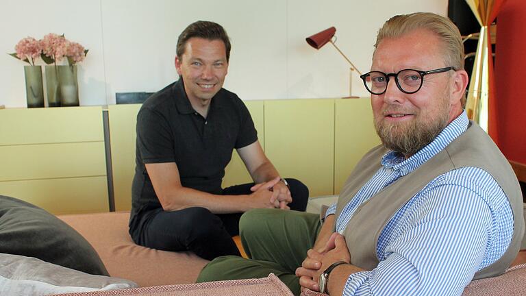 Wenn ein Psychologe das Büro plant       -  Bei Besprechungen im Job darf es auch mal gemütlich zugehen: Daniel Rüttiger (rechts) und Jochen Bähr sind die Geschäftsführer von 'Büroforum' in Würzburg. Das Unternehmen hat sich wegbewegt vom reinen Handel mit Büromöbeln hin zum Komplettplaner von großen Büros. Rüttiger setzt dabei auf sein Wissen als Psychologe.