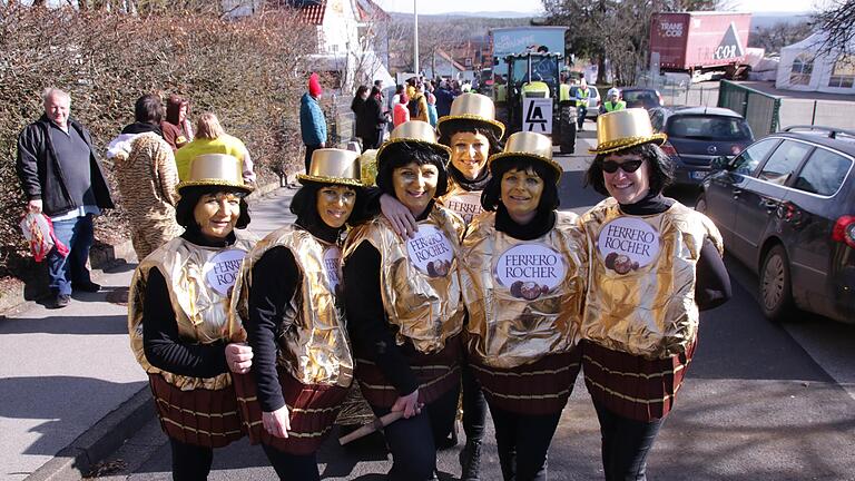 Die Frauen vom Faschingsstammtisch Stangenroth, alles frühere Gardetänzerinnen, laufen beim Umzug in ihrem Heimatort als goldene Ferrero-Pralinen mit.       -  Die Frauen vom Faschingsstammtisch Stangenroth, alles frühere Gardetänzerinnen, laufen beim Umzug in ihrem Heimatort als goldene Ferrero-Pralinen mit.