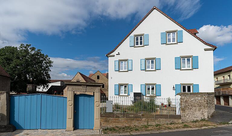 Das neugebaute Wohnhaus der Familie Ruhl in der Mainstraße in Hergolshausen, mit der Sandsteinpforte und dem Brunnen (links neben der Mauer)