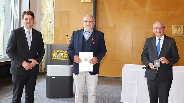 Innenstaatssekretär Sandro Kirchner (links) überreichte im Beisein von Regierungspräsident Eugen Ehmann (rechts) die Ordensinsignien an Manfred Haas.