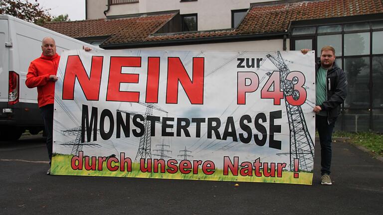 Axel Höfler und Sohn Lorenz aus Höllrich standen vor der Halle mit einem Plakat gegen die 'Monstertrasse'