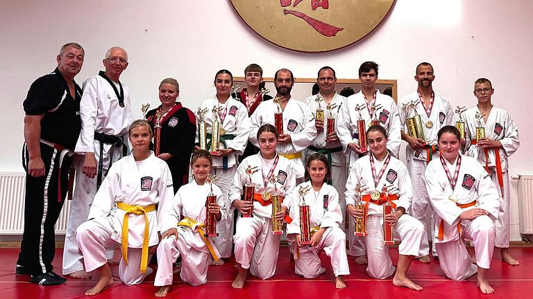 Auf dem Foto (von links): Patrick Paolozzi (1. Abteilungsleiter und Trainer, Keichu Do Karate TSV Rottenbauer), Uwe Mandler (Black Belt Centers Mandler, Worms), Lea Winkler (Trainerin Keichu Do Karate TSV Rottenbauer), daneben und davor die erfolgreichen Karatekas des TSV Rottenbauer.