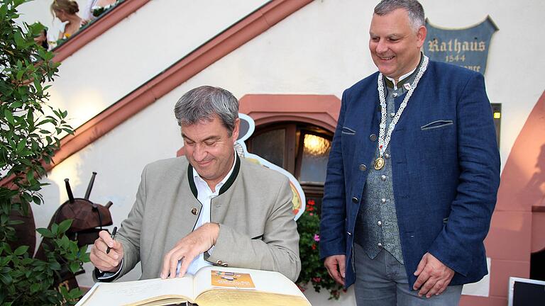 Beim Empfang zum Auftakt des 73. Fränkischen Weinfests in Volkach trug sich Ministerpräsident Markus Söder im Beisein von Bürgermeister Heiko Bäuerlein in das Goldene Buch der Stadt ein. Beim Empfang zum Auftakt des 73. Fränkischen Weinfests in Volkach trug sich Ministerpräsident Markus Söder im Beisein von Bürgermeister Heiko Bäuerlein in das Goldene Buch der Stadt ein.