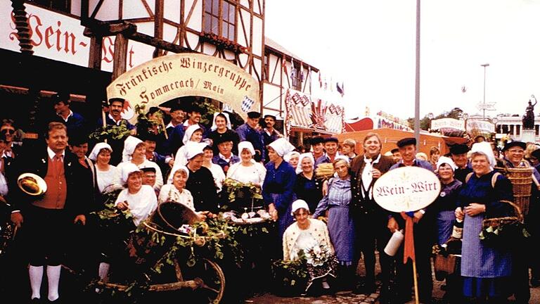 Die Winzergruppe Sommerach und Musiker der Stadtkapelle Volkach vor dem Weinzelt beim Oktoberfest 1984.