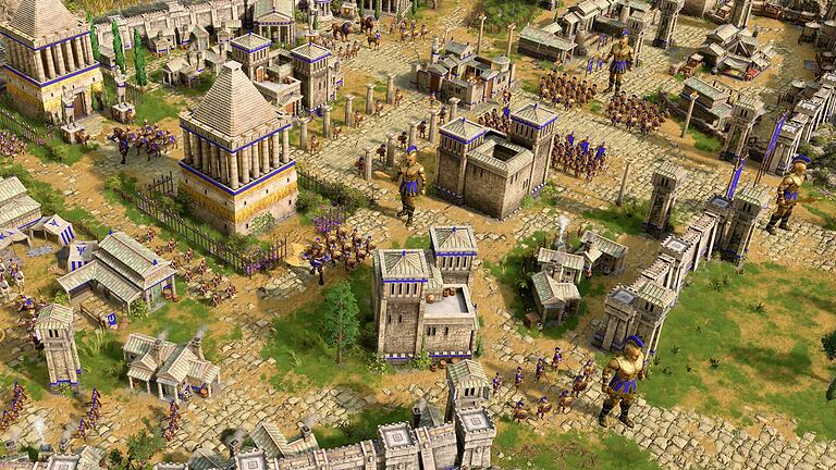 Screenshot vom Spiel &bdquo;Age of Mythology: Retold&rdquo;       -  Zahlreiche Einheiten schützen die Siedlung vor gegnerischen Angriffen.