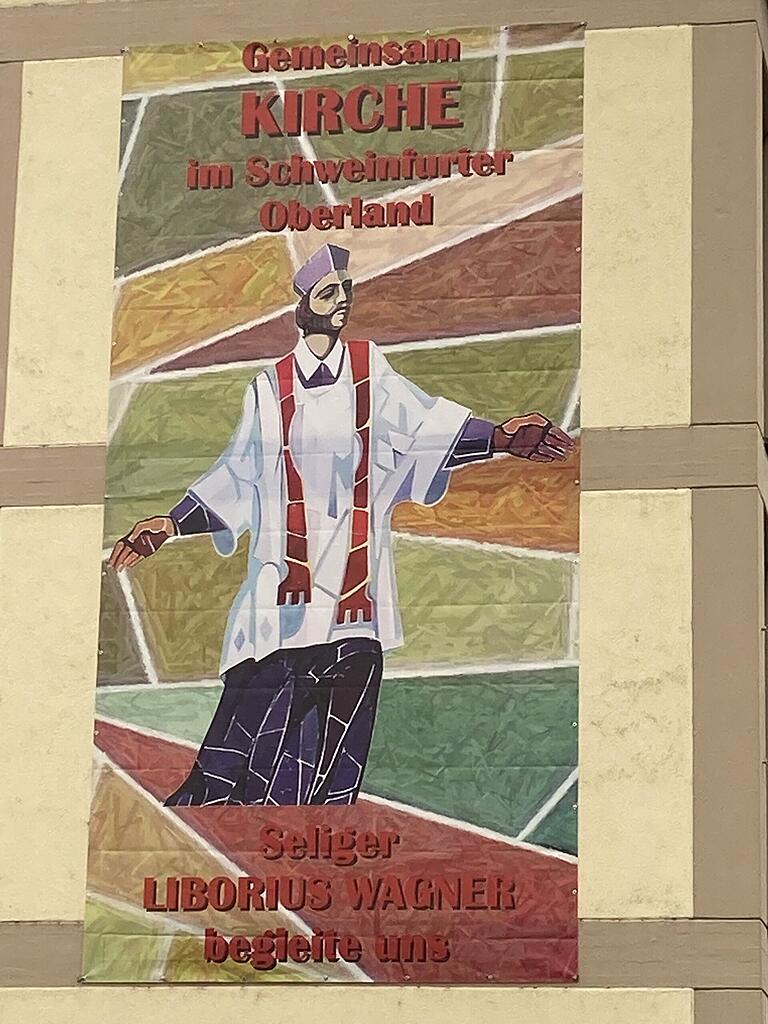 Liborius Wagner als Patron des Pastoralen Raumes Schweinfurter Oberland auf einem Plakat an den Hauptkirchen. Das Foto entstand an der Pfarrkirche Stadtlauringen. Liborius Wagner als Patron des Pastoralen Raumes Schweinfurter Oberland auf einem Plakat an den Hauptkirchen. Das Foto entstand an der Pfarrkirche Stadtlauringen.