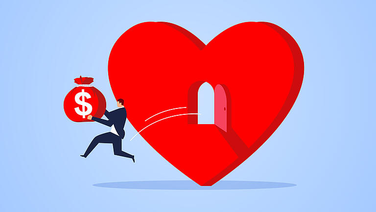 Love money, businessman holding money bag and jumping out of heart shape       -  Symbolbild: Liebe & Geld