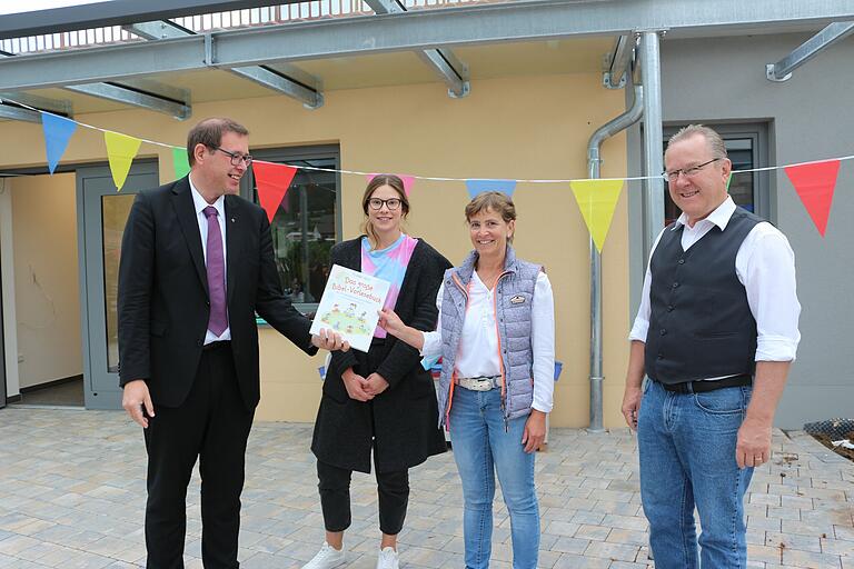 Einstandsgeschenk des neuen Trägers: Im Namen der evangelischen Kirchengemeinde Urspringen überreichte Pfarrer Oliver Englert (links) 'Das große Bibel-Vorlesebuch' an die stellvertretende Kindergartenleiterin Laura Dietz und Kindergartenleiterin Eva Herbert. Bürgermeister Thomas Fischer (rechts) freut sich als Vorsitzender des St.-Johannesverein darüber, die Einrichtung in die Hände eines erfahrenen neuen Trägers übergeben zu können. Einstandsgeschenk des neuen Trägers: Im Namen der evangelischen Kirchengemeinde Urspringen überreichte Pfarrer Oliver Englert (links) 'Das große Bibel-Vorlesebuch' an die stellvertretende Kindergartenleiterin Laura Dietz und Kindergartenleiterin Eva Herbert. Bürgermeister Thomas Fischer (rechts) freut sich als Vorsitzender des St.-Johannesverein darüber, die Einrichtung in die Hände eines erfahrenen neuen Trägers übergeben zu können.