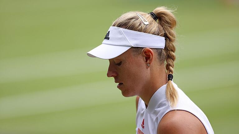 Angelique Kerber       -  Um auf dem heiligen Rasen zu glänzen, muss Angelique Kerber so einiges abschütteln.