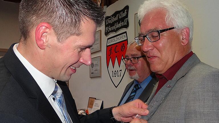 Unermüdlich am Schaffen und Organisieren: Ansgar Willacker (rechts), der Vorsitzende des FC Gerolzhofen, wurde vom stellvertretenden BFV-Vorsitzenden Jürgen Pfau letztes Jahr mit der Ehrennadel ausgezeichnet. Jetzt folgte der Ehrenamtspreis im Fußball-Kreis Schweinfurt. Vorgeschlagen hatte ihn der FCG-Ehrenamtsbeauftragte Karl-Heinz Mock (im Hintergrund). Unermüdlich am Schaffen und Organisieren: Ansgar Willacker (rechts), der Vorsitzende des FC Gerolzhofen, wurde vom stellvertretenden BFV-Vorsitzenden Jürgen Pfau letztes Jahr mit der Ehrennadel ausgezeichnet. Jetzt folgte der Ehrenamtspreis im Fußball-Kreis Schweinfurt. Vorgeschlagen hatte ihn der FCG-Ehrenamtsbeauftragte Karl-Heinz Mock (im Hintergrund).